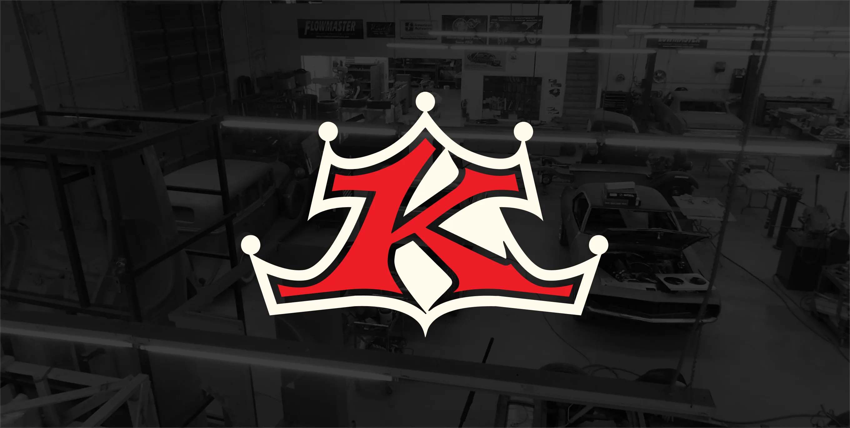 The Kindig-It crown K logo over a black-and-white photo of the workshop floor