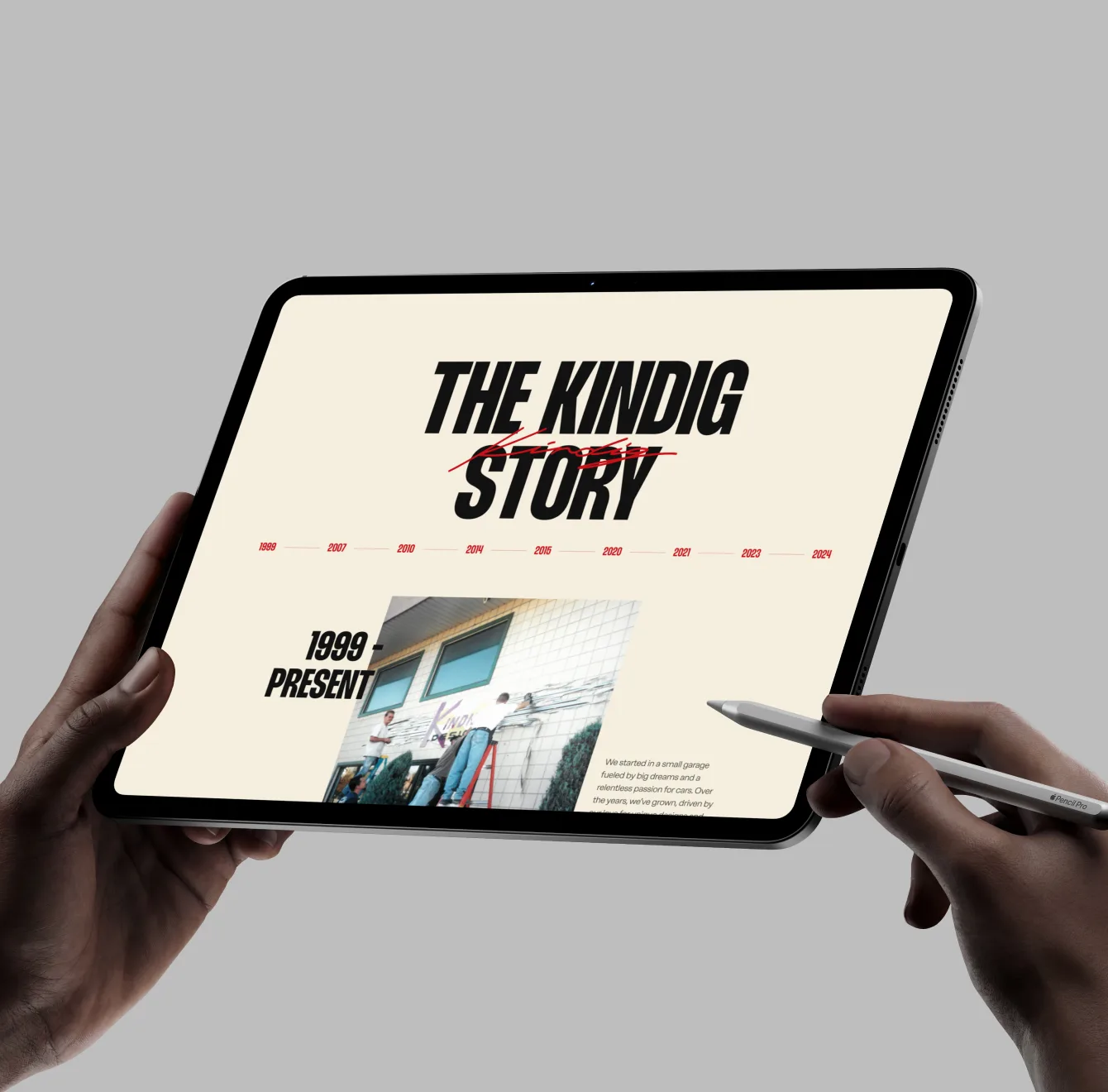 Kindig-It pages fanned out over a gray backdrop