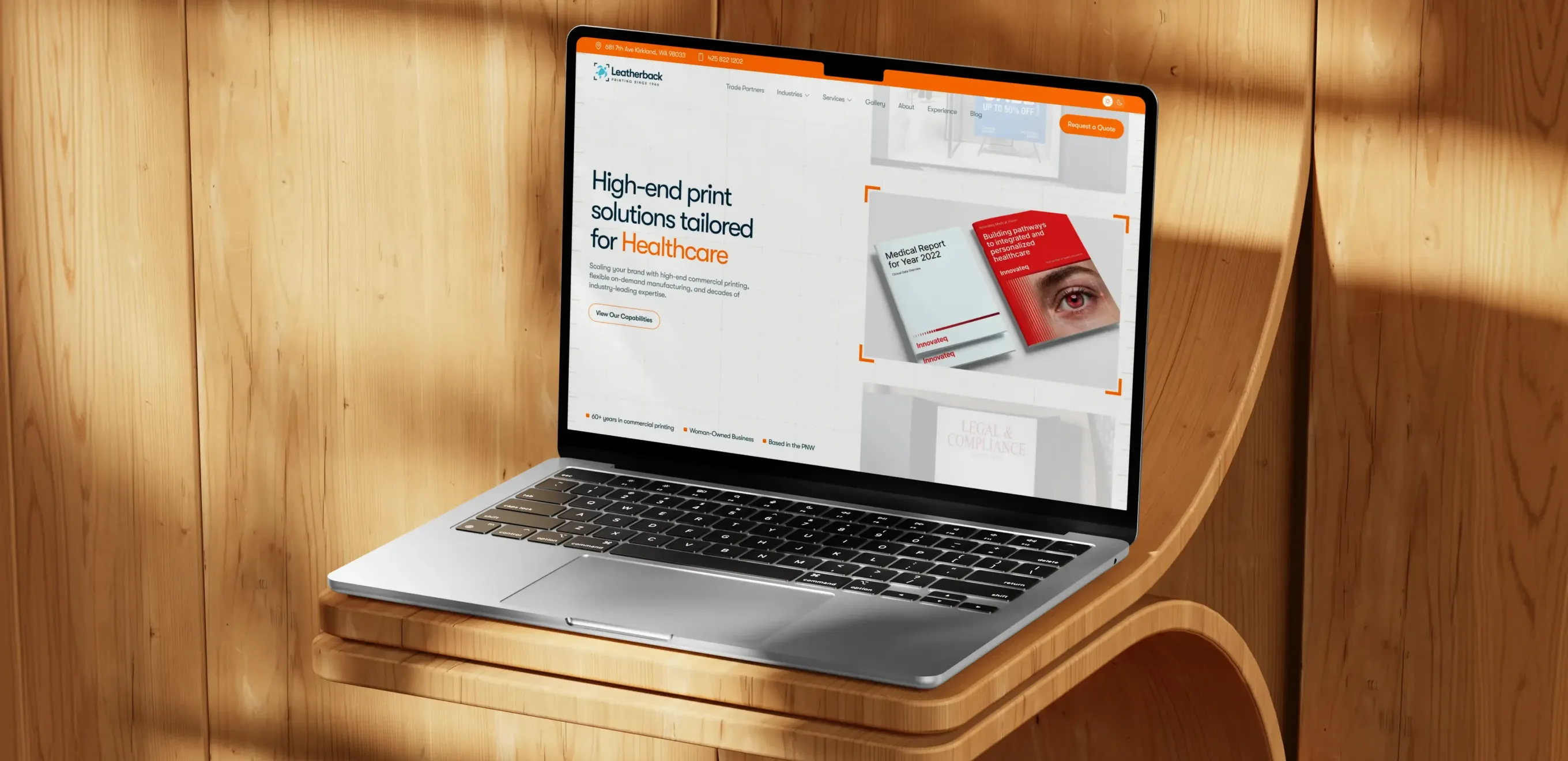 Laptop on a wooden shelf showing the new Leatherback Printing healthcare landing page